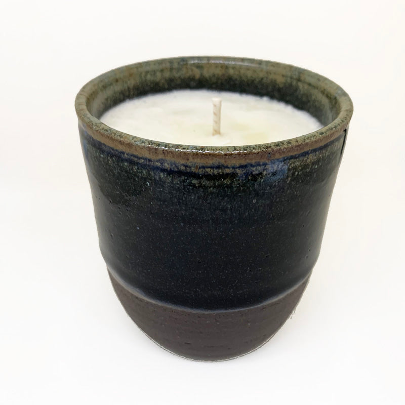 close up view of unlit ceramic vessel candle